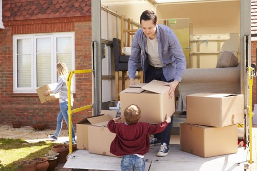 Moving van and packed boxes representing the booking process for a man and van service