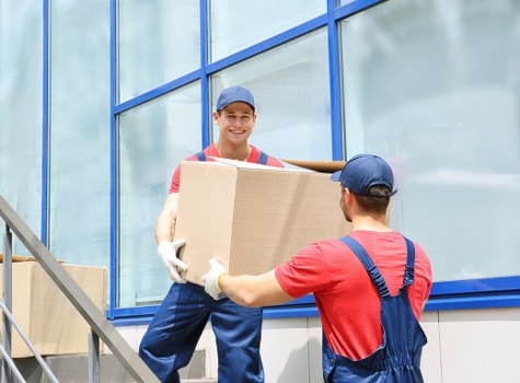 Protected movers loading furniture into a van safely