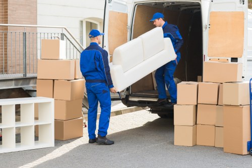 Team member loading boxes safely into a van